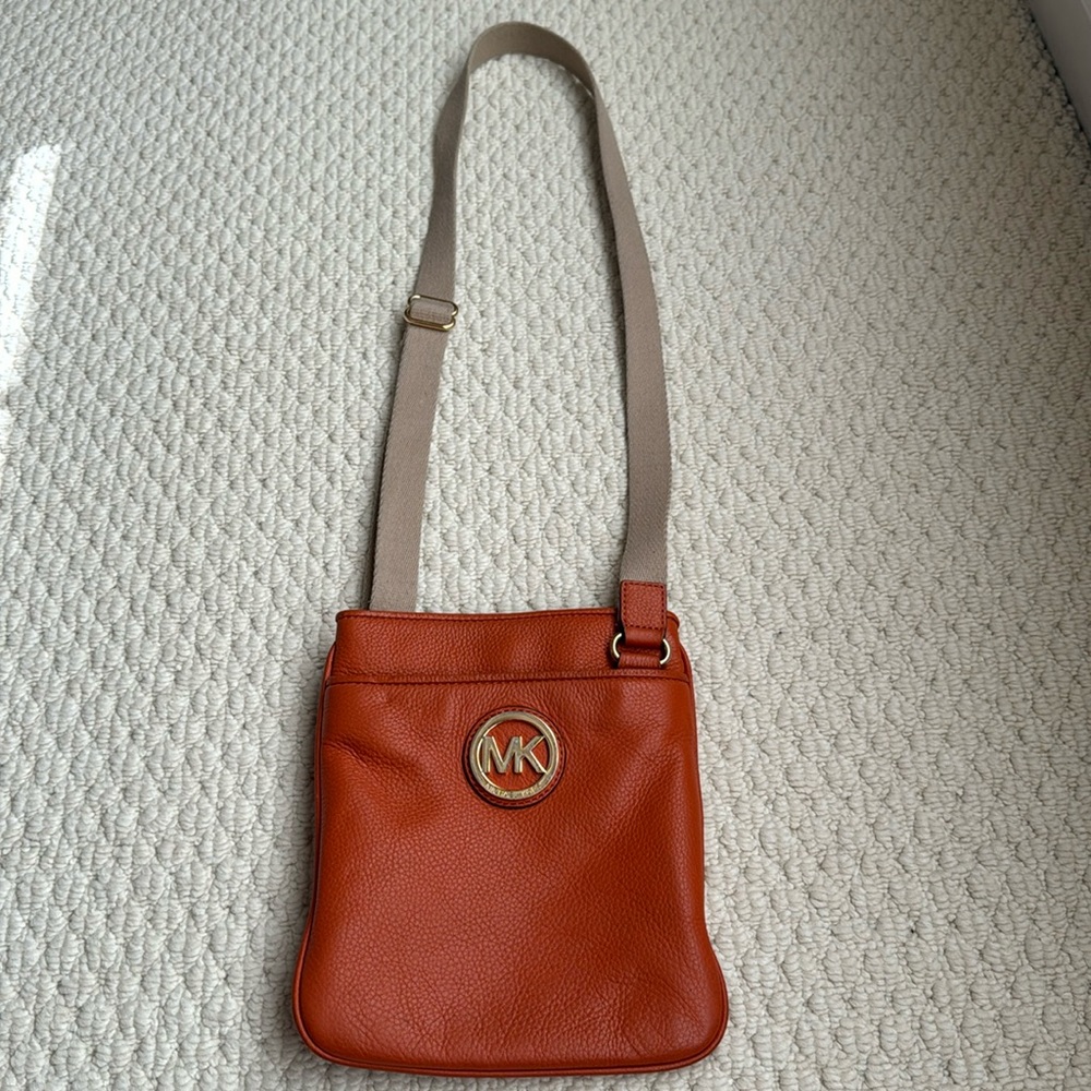 Michael Kora orange crossbody bag.